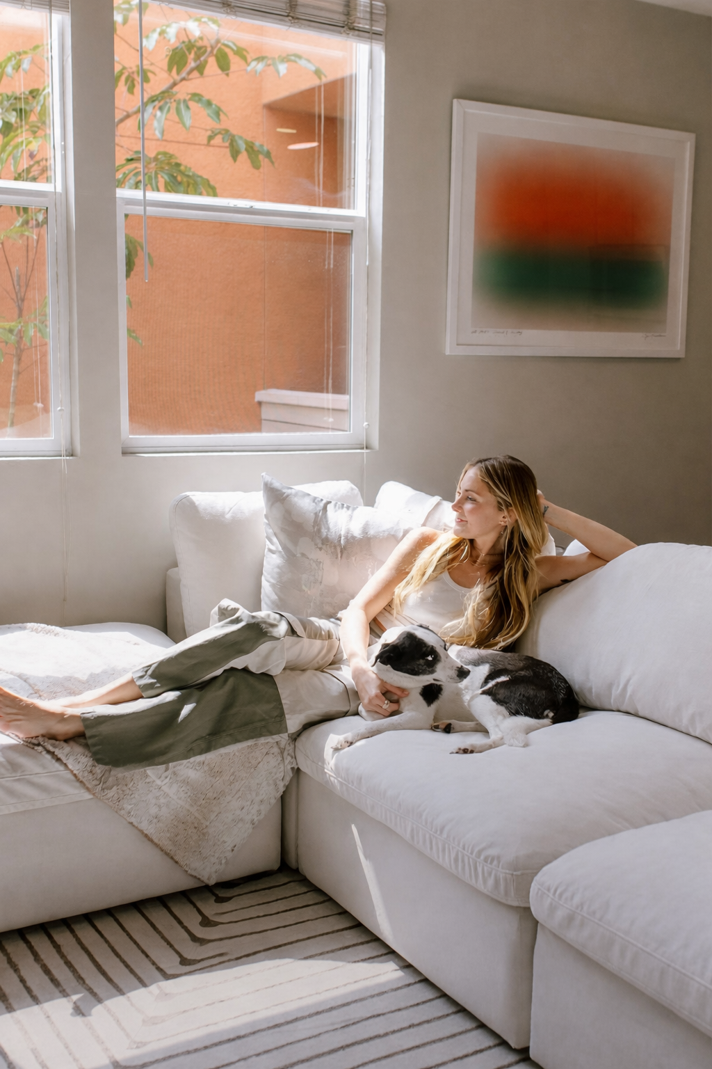 Lady sitting on couch with dog